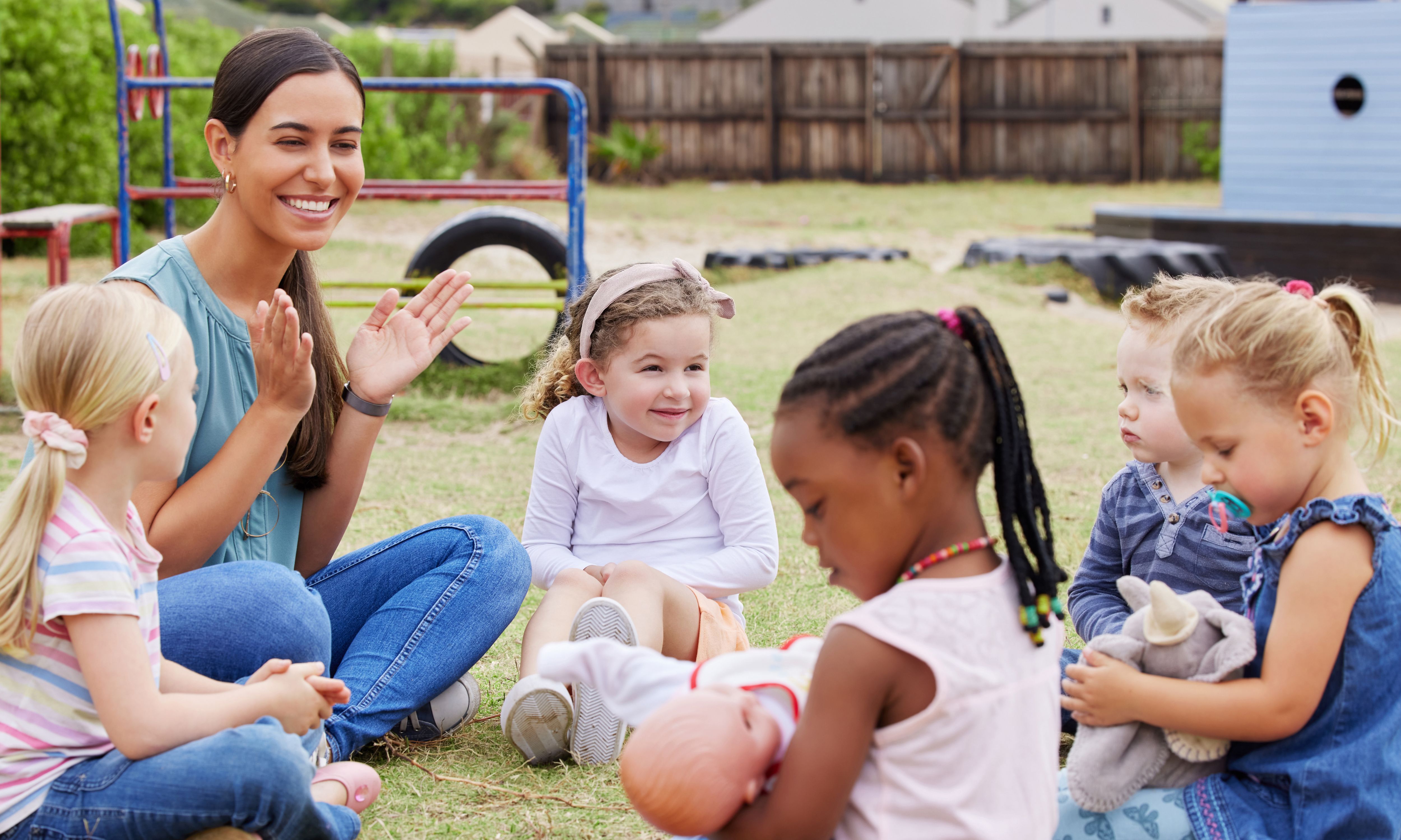 Early years worker working with group of children 