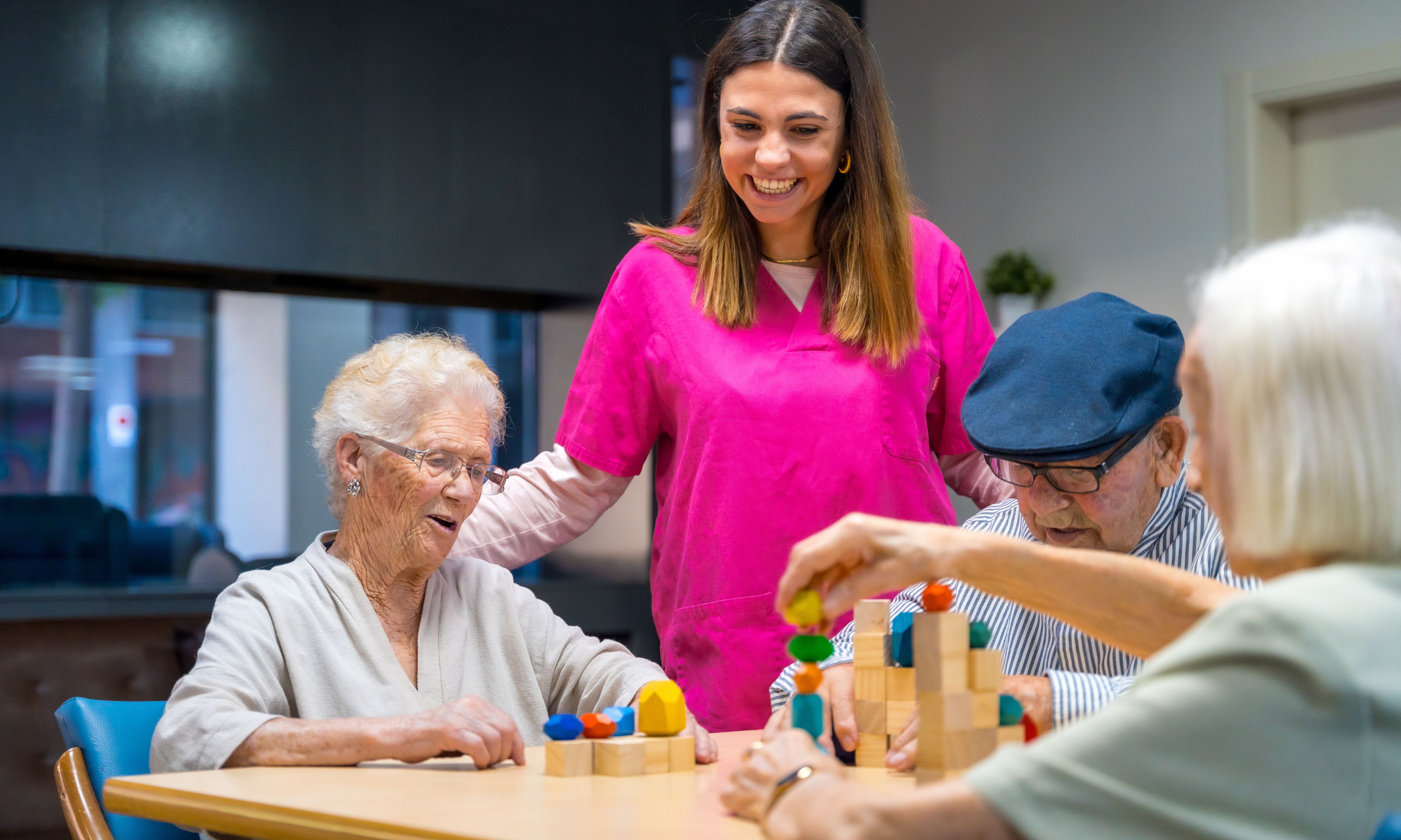 Adult care worker supporting older people in care setting